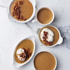 three white bowls filled with different types of food on top of a marble countertop