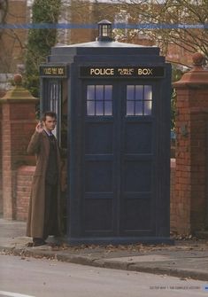 a man standing in front of a police box