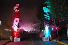 several colorfully lit sculptures on the side of a road