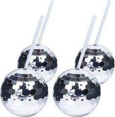 three shiny metal balls with white handles and one has two straws sticking out of it