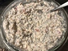 a bowl filled with oatmeal sitting on top of a table next to a spoon