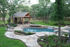 a backyard with a pool and hot tub