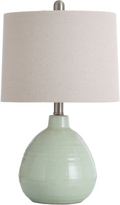 a light green table lamp with a white shade