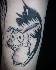 a black and white cartoon character tattoo on the leg