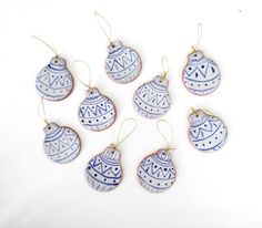 six blue and white ornaments hanging from strings