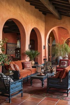 a living room filled with furniture and potted plants on top of it's tables