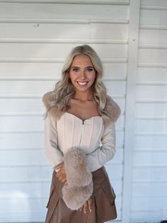 Stunning Fur trim beige crop top with corset like body and front zipper. Model is 5'4" with a 25" waist, 32" bust, and 32" hips wearing a small. Chic Beige Crop Top For Winter, Chic Fitted Beige Crop Top, Beige Fitted Chic Corset, Chic Fitted Beige Corset, Chic Beige Corset For Night Out, Cream Cropped Crop Top For Fall, Chic Fitted Crop Top With Zipper Closure, Fitted Beige Corset Belt For Spring, Chic Fitted Cream Corset