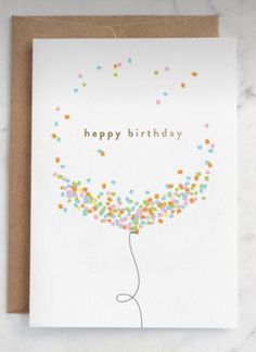 a happy birthday card with confetti on the bottom and a balloon in the middle