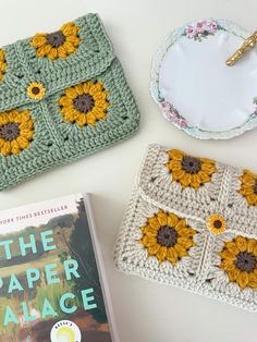 two crocheted sunflowers and a book on a table