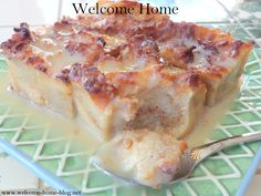 a close up of a plate of food on a table with a welcome home sign in the background