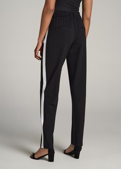 About Our Pull On Tuxedo Stripe Pants for Tall Women Shopping for pants for tall women can be a pain. We know the struggle of finally finding a pant that's long enough while finding the rest of the size is much too big. That’s why we’ve created these tall women’s pants intentionally for heights from 5’9 to 6’6, with the extra-long inseam you need, and none of the baggage you don’t. These pull-on bottoms are an elevated everyday option with their draping, stretch-infused fabric and front knife pl Black Stretch Pants With Side Stripes, Stretch Black Pants With Side Stripes, Full Length Pants With Side Stripes, Black Straight Pants With Elastic Side Panels, Black Trousers With Side Stripes, Black Full-length Bottoms With Side Stripes, Black Full Length Bottoms With Side Stripes, Black Pants With Elastic Side Panels For Work, Black Trousers With Elastic Side Panels