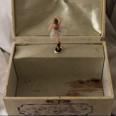 a small figurine is in an open box