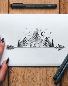 a drawing of mountains and trees with an arrow in the foreground, on top of a piece of paper