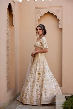 Ivory raw silk lehenga with finest kundan and zardozi embellishments , paired with elbow sleeve embroidered blouse and organza zardozi and pearl work dupatta.From Chamee and Palak's The Romantics collection.DELIVERY TIMEPlease allow 8-12 weeks for your outfit to arrive.FABRIC DETAILSRaw Silk, OrganzaProfessional cleaning only. Elegant Gota Work Choli For Festive Season, Elegant Semi-stitched Choli With Gota Work, Elegant Semi-stitched Gota Work Choli, Elegant Traditional Wear With Gota Work For Reception, Elegant Designer Choli With Gota Work, Elegant Choli With Gota Work For Diwali, Elegant Gota Work Choli For Diwali, Elegant Navratri Choli With Gota Work, Elegant Gota Work Choli For Navratri