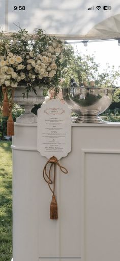 an outdoor ceremony with white flowers and greenery