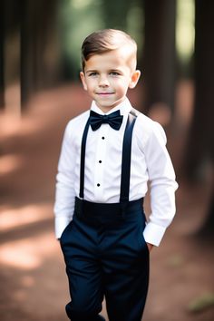 a young boy in a tuxedo and bow tie is posing for a photo