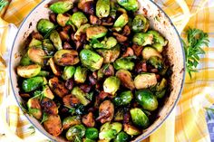 brussel sprouts in a pan on a yellow and white checkered table cloth