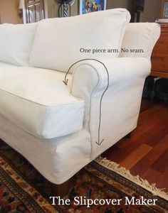 a white couch sitting on top of a wooden floor