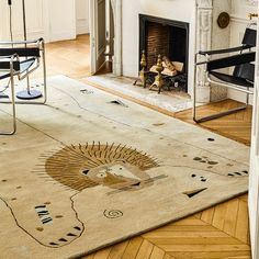 a living room with a fire place and rug on the floor