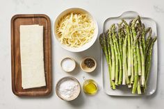 asparagus, parmesan cheese and other ingredients laid out on a table