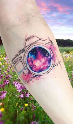 a person's arm with a tattoo on it that has an image of a camera in