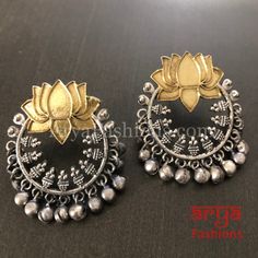 Lotus Flower Dual Tone Golden Oxidized Chandbali Earrings Made in Brass with Oxidized Silver Dual/Two Tone Finish and colored stones Very Elegant and stylish, these earrings can be paired with any traditional Indian or Western Attire depending upon the occasion and the theme. Length: Approx. 1.65 Inches Earrings come with Push Back Closure In-stock & ready-to-ship **Color may vary slightly due to photography and lighting. Pick-up available for this item at 5336 Heather Brook Ln. Glen Allen, 2305 Traditional Flower Jewelry For Diwali, Traditional Flower-shaped Jewelry For Diwali, Traditional Silver Flower Earrings, Traditional Flower Earrings For Festive Occasions, Traditional Silver Drop Flower Earrings, Traditional Silver Flower Earrings For Festive Occasions, Bohemian Dual-tone Earrings For Festivals, Traditional Flower-shaped Earrings, Silver Flower Earrings For Celebration