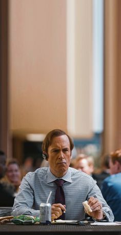 a man sitting at a table with food in front of him