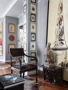 a living room filled with furniture and pictures on the wall