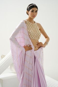 Lilac satin silk saree with sequin embroidery in stripe pattern. Paired with crystal embroidered blouse.
Components: 2
Pattern: Embroidery
Type Of Work: Sequin, crystal
Neckline: Round
Sleeve Type: Sleeveless
Fabric: Satin Silk
Color: Purple
Other Details: 
Back deep square neck
Occasion: Reception - Aza Fashions Silk Blouse Piece With Gota Work For Reception, Georgette Blouse With Gota Work, Georgette Pre-draped Saree With Gota Work, Pre-draped Georgette Saree With Gota Work, Unstitched Gota Work Blouse Piece For Reception, Silk Blouse Piece With Mirror Work For Reception, Bollywood Tissue Silk Blouse With Gota Work, Bollywood Style Tissue Silk Blouse With Gota Work, Bollywood Style Blouse With Gota Work On Tissue Silk