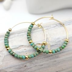 "Get ready to add a touch of bohemian charm to your jewelry collection with these 14k gold filled Bohemian hoop earrings featuring stunning turquoise colored seed beads. Handmade with care, these earrings are a unique and eye-catching addition to your wardrobe. The 14k gold filled material ensures that these earrings are durable and long-lasting, making them perfect for everyday wear. The turquoise colored beads add a pop of color and create a tribal look that's perfect for summer and beyond. Th Beaded Jewelry Earrings, Silver Threader Earrings, Boho Hoop Earrings, Sea Glass Earrings, Turquoise Boho, Homemade Jewelry, Earring Cards, Absolutely Fabulous, Beads Handmade