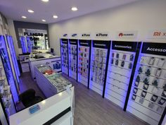 an electronics store with many electronic devices displayed on the walls and in front of them