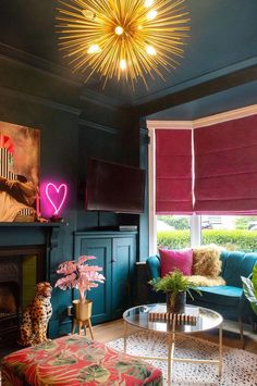 a living room filled with furniture and a flat screen tv mounted on the wall above a fire place