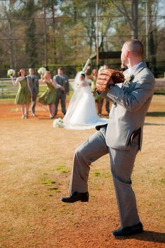 a man in a gray suit holding a baseball mitt