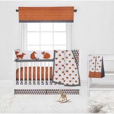 a baby crib bedding set with foxes and stars on it, next to a window