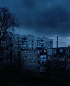 the sky is dark and cloudy over some buildings