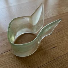 a white bowl sitting on top of a wooden floor