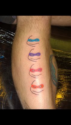 a man's leg with different colored lines on it and the word love written in black ink