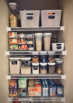 the pantry shelves are organized with containers and bins to keep food in, or for storage