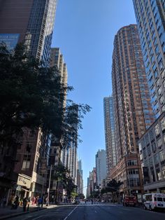 an empty city street with tall buildings in the background