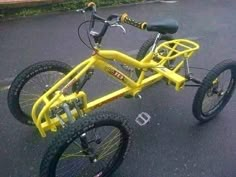 a yellow bicycle parked in a parking lot