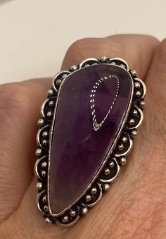 Vintage purple amethyst cocktail ring statement Large genuine free form amethyst Vintage ring Low content silver not sterling. Our jeweler charges a $20 re sizing fee. All rings are shipped free in the US in a nice gift box. Check out our over a THOUSAND great reviews Engraving is $4 per letter and is not always perfect depending on the piece. It can take a few days if the jeweler is busy. This is payable to Paypal Judithsltd@gmail.com Teardrop Amethyst Ring In Purple, Amethyst Ring With Natural Stones For Anniversary, Oval Purple Amethyst Ring With Natural Stones, Oval Amethyst Ring With Natural Stones, Purple Teardrop Amethyst Ring, Unique Purple Ring With Large Stone, Unique Silver Amethyst Ring With Large Stone, Unique Oval Amethyst Ring, Handmade Purple Amethyst Ring Collectible