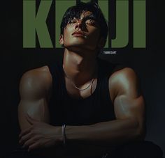 a young man with his arms crossed on the cover of kpop magazine, wearing a black tank top