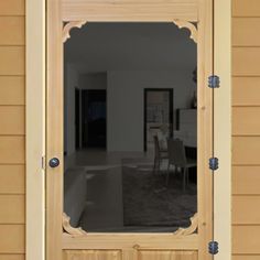 the reflection of a living room and dining room in a mirror on a wooden door