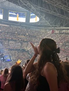 a woman standing in front of a crowd at a concert