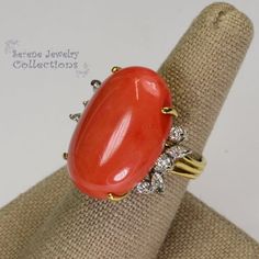 This rare Japanese Momo Coral Ring is set in 18k solid gold. 6 round diamonds and 4 marquise diamonds surround the coral.Ring Size: 6Total Weight: 11.7 gramsPrecious Metal: 18k solid goldPrecious stones:-Coral Center Stone: 25.5mm x 17.8mm-White Round and Marquise Diamonds Elegant Oval Coral Rings, Elegant Coral Oval Rings, Elegant Coral Rings For Anniversary, Luxury Coral Jewelry For Formal Occasions, Elegant Coral Ring Jewelry, Formal Coral Ring, Coral Elegant Wedding Rings, Elegant Coral Wedding Rings, Elegant Coral Jewelry For Anniversary