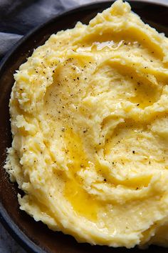 mashed potatoes on a plate with mustard and seasoning