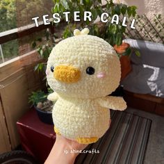 a hand holding a small stuffed animal with the words testercall on it