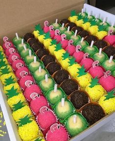 a box filled with lots of different colored cakes