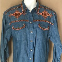 Cambridge Country Store Denim Shirt Style: Button Down Shirt, Front Pockets, Embroidered Detail, 100% Cotton Color: Denim Blue Denim Multi Color Embroidery Detail Size: Large Condition: New Never Worn Embroidered Button-up Western Tops, Embroidered Denim Blue Top For Fall, Western Style Embroidered Button-up Top, Embroidered Button-up Denim Blue Top, Embroidered Denim Blue Button-up Top, Western Style Blue Tops With Buttons, Medium Wash Long Sleeve Embroidered Denim Top, Casual Embroidered Button-up Denim Top, Embroidered Long Sleeve Denim Shirt