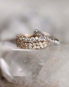 two wedding rings sitting on top of each other